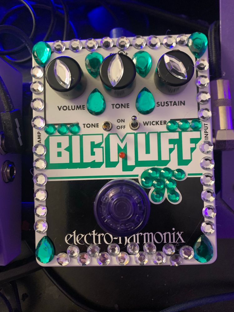 a bejeweled Big Muff Pi guitar pedal. it’s the green one