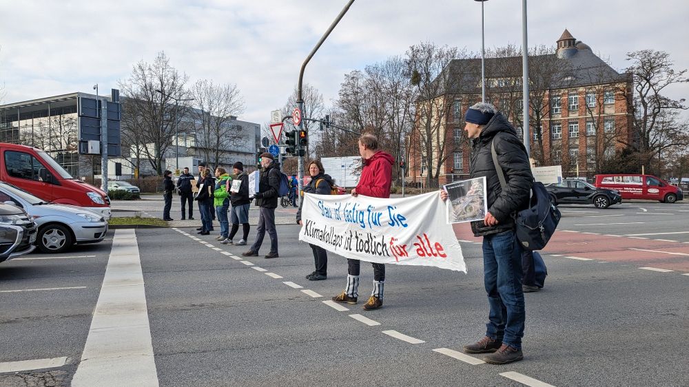 Elne Gruppe von Menchen steht mit Bannern und Schildern auf einer Straße