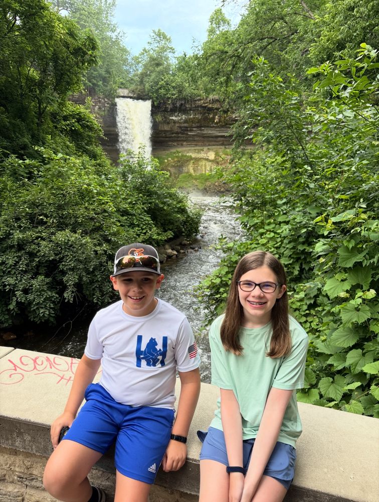 two kids posed in front of minnehaha falls