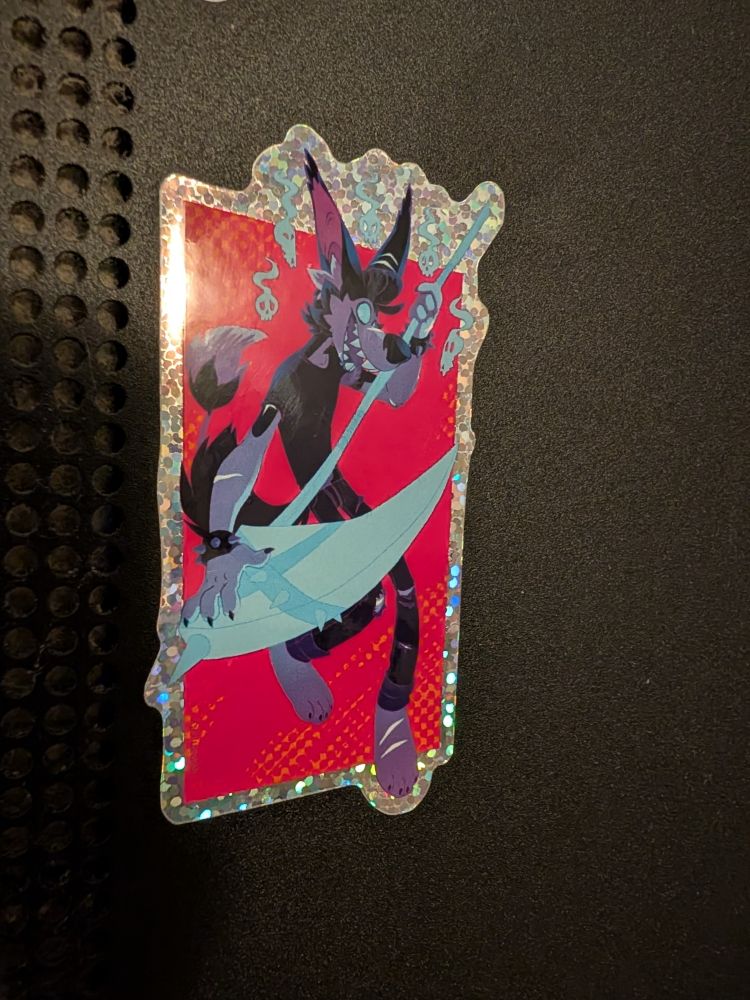 A cartoon wolf man with a glowing blue, ghostly scythe, and its tongue hanging agape, staring with mischievous intent.