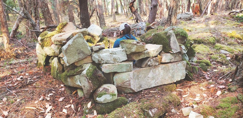 I am still crouched inside the circular stone structure, only this is a photo of the back of my head taken from outside of the structure