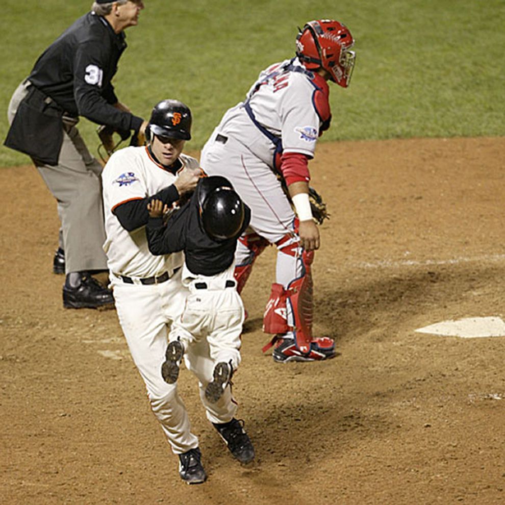 JT Snow grabs 3 year old bat boy Darren Baker and pulls him to safety in the 2002 World Series