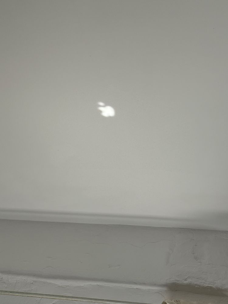 Apple logo reflected on the ceiling 