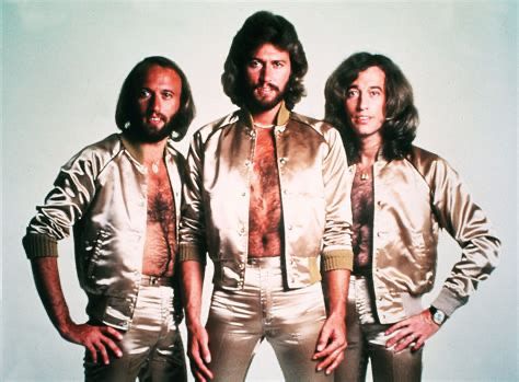 The Bee Gees in ravishing chest-baring golden outfits.