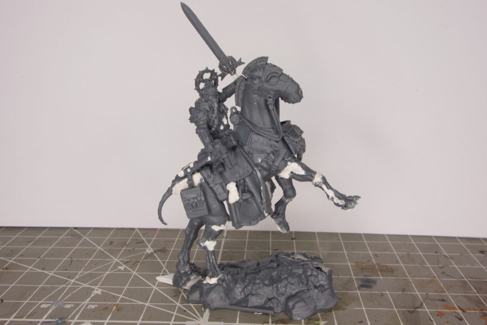 A customized version of Games Workshop’s miniature of Lord Marshal Dreir for the game Warhammer 40k, with the intention to use it as Lord Solar Leontus. The main changes are: The Krieg Mount is prancing, “Dreir” is holding a sword instead of the usual sabre, and he is looking to his right .