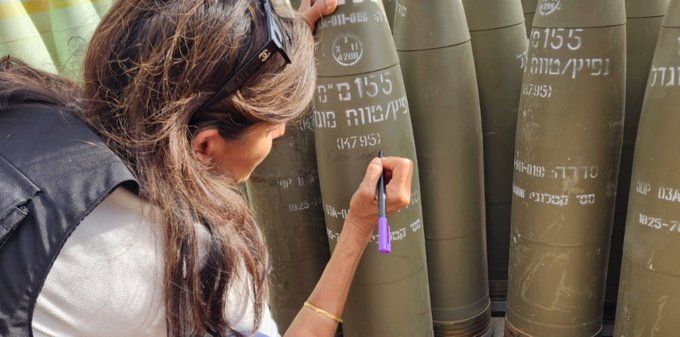 Dear Americans, Nikki Haley visited us today: She went to the West Bank settlements and then went to sign on a bomb "finish them". Just disgusting. Can you please take her back? We already have one Ben Gvir & we don't need your filthy death promoting politicians as well. Thanks!