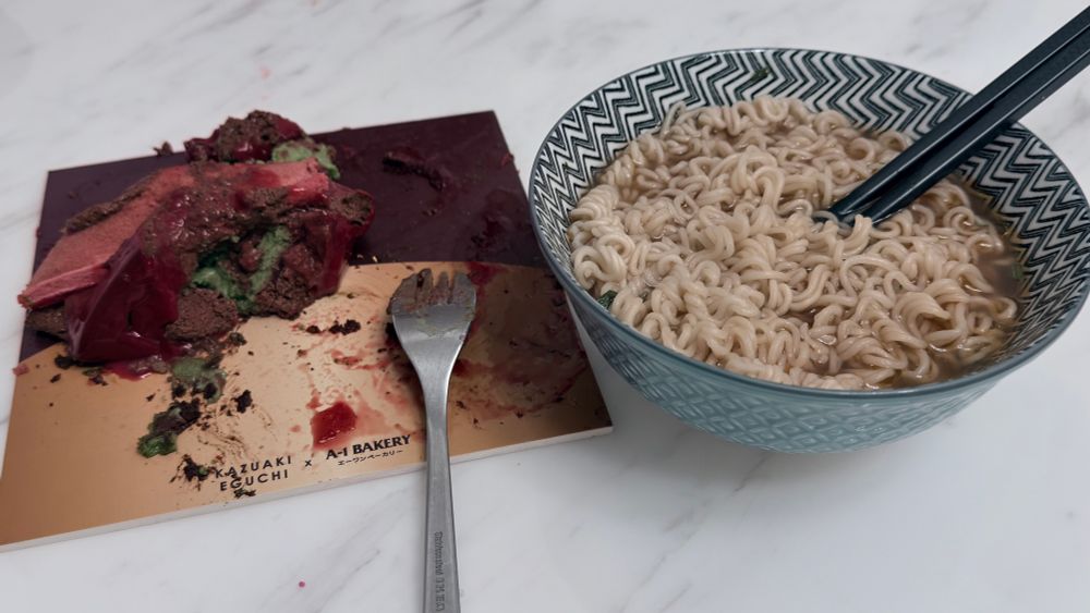 A picture containing a literal pile of melted strawberry pistachio cake on the left, and a bowl of bland instant noodles flavoured with sesame oil on the right.