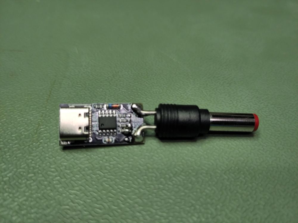 A barrel plug soldered to a small usb-c power delivery board. Not perfectly aligned, but good enough to work.