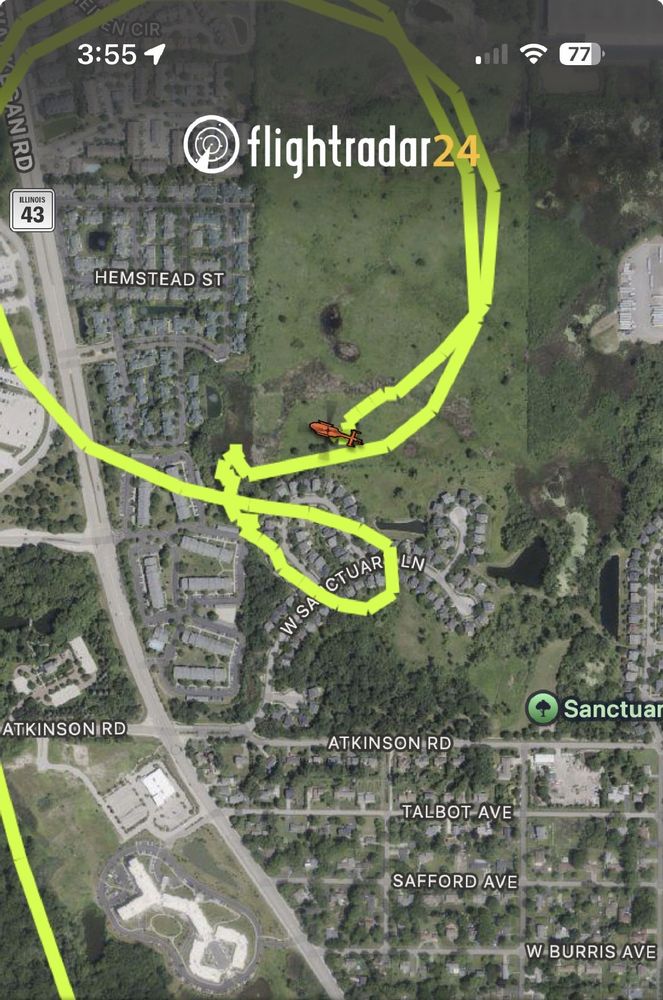 News helicopter is circling over a wetland and the neighborhoods bordering it. 