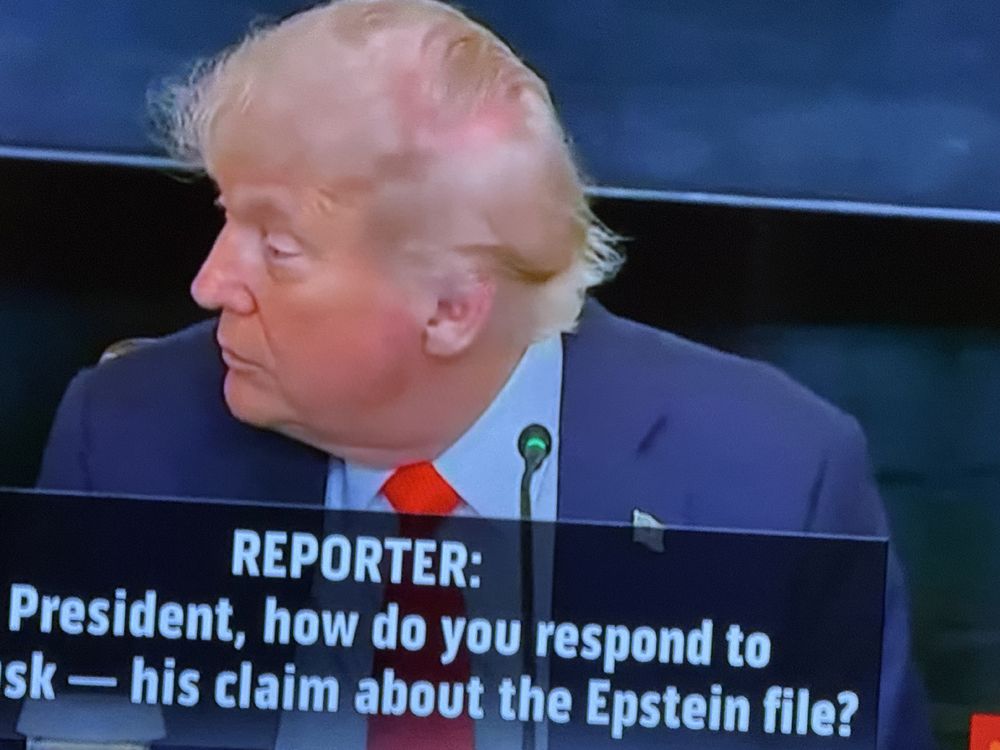 Screenshot of Trump turned to his right, exposing a large pink area of scalp where his elaborately woven combover has shifted. His expression is wary, his chin is flabby and weak.

Caption on screen says

Reporter: Mr President, how do you respond to this claim about the Epstein files?