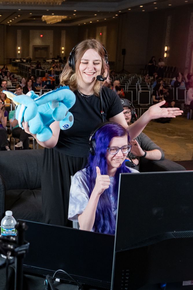 A photo right after completion of the last blindfolded puzzle, where Izzy removes the Vaporeon plushie and Greta flashes a thumbs up. 