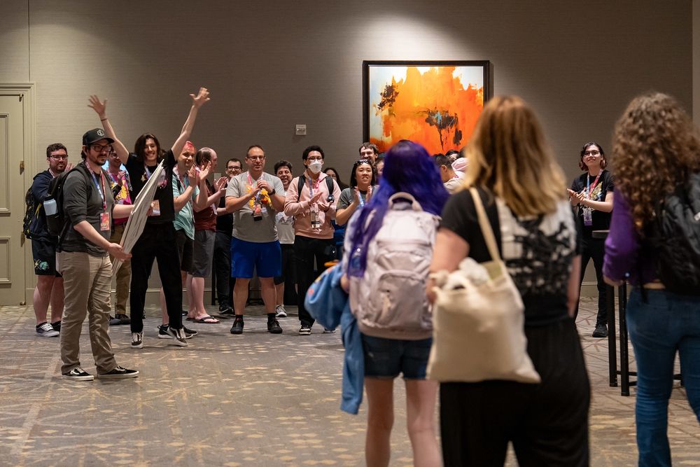 A photo taken after the SwSh run, right as Greta, Izzy, and May walked out from the backstage area to be greeted by the PSR community. People are clapping and generally excited.