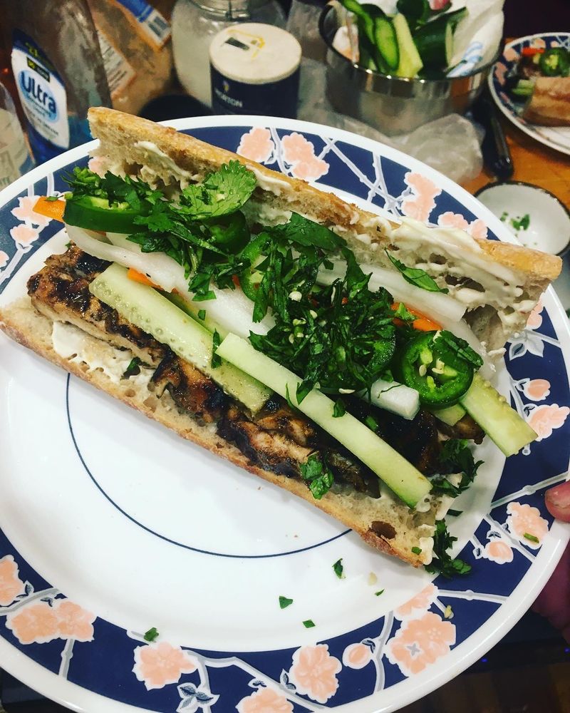 Bahn Mi sandwich with chicken, cucumber, viet pickle, jalapeño, and cilantro.
