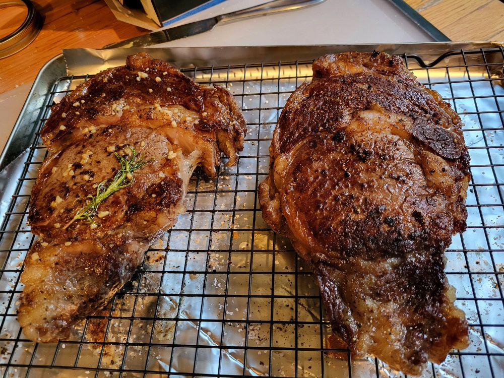 Two seared ribeyes.