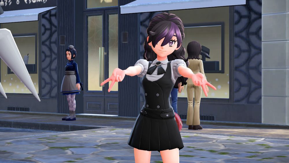 Screenshot from the game Pokemon Legends Z-A of the female protagonist, styled with long black hair with purple streaks and a fringe that covers one eye. She's wearing a somewhat gothic outfit, with a black waistcoat and skirt, and is throwing double peace signs at the camera.