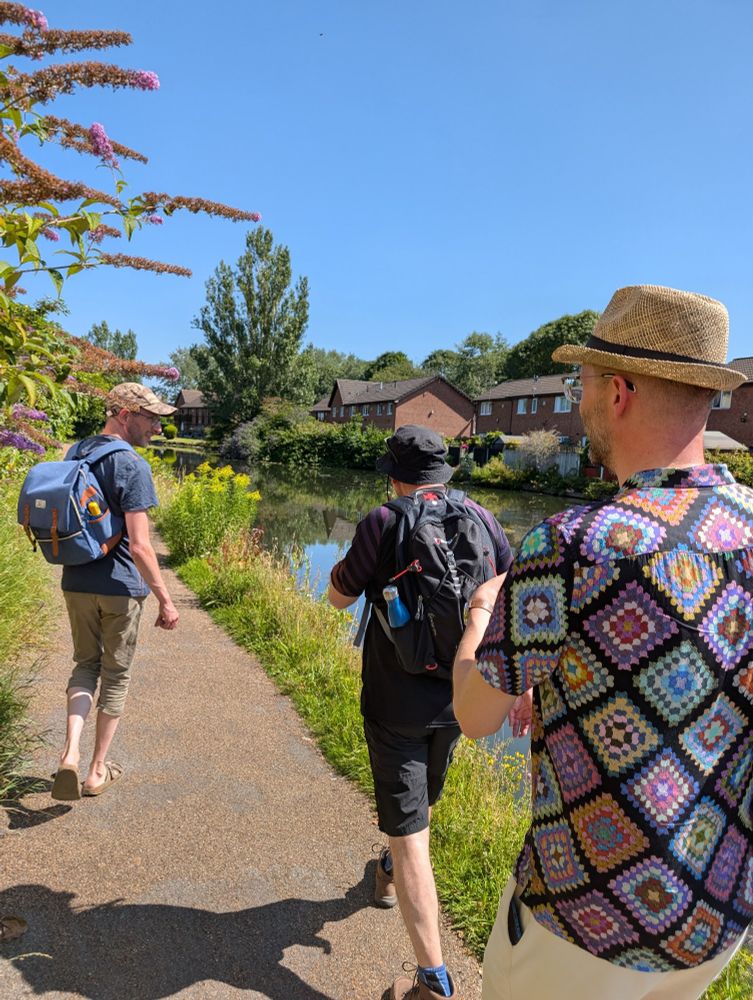 Three friends walking along the river
