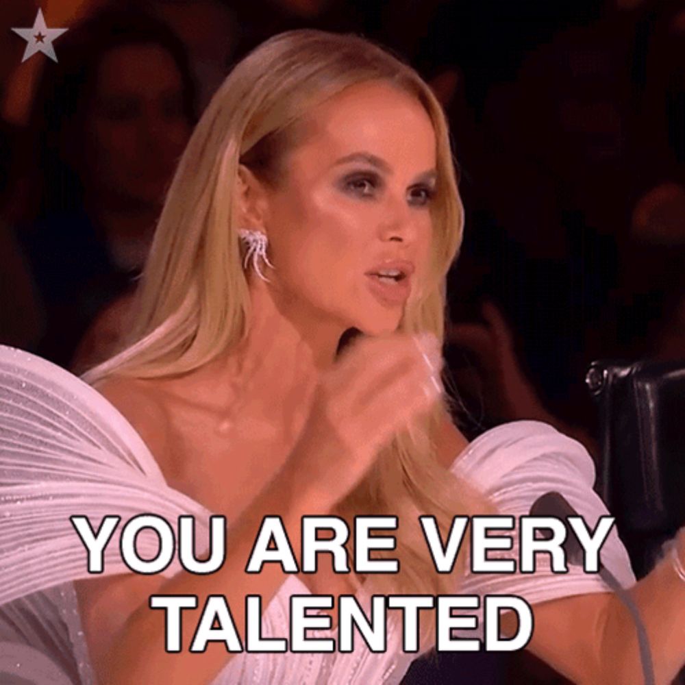 a blonde woman in a white dress says you are very talented