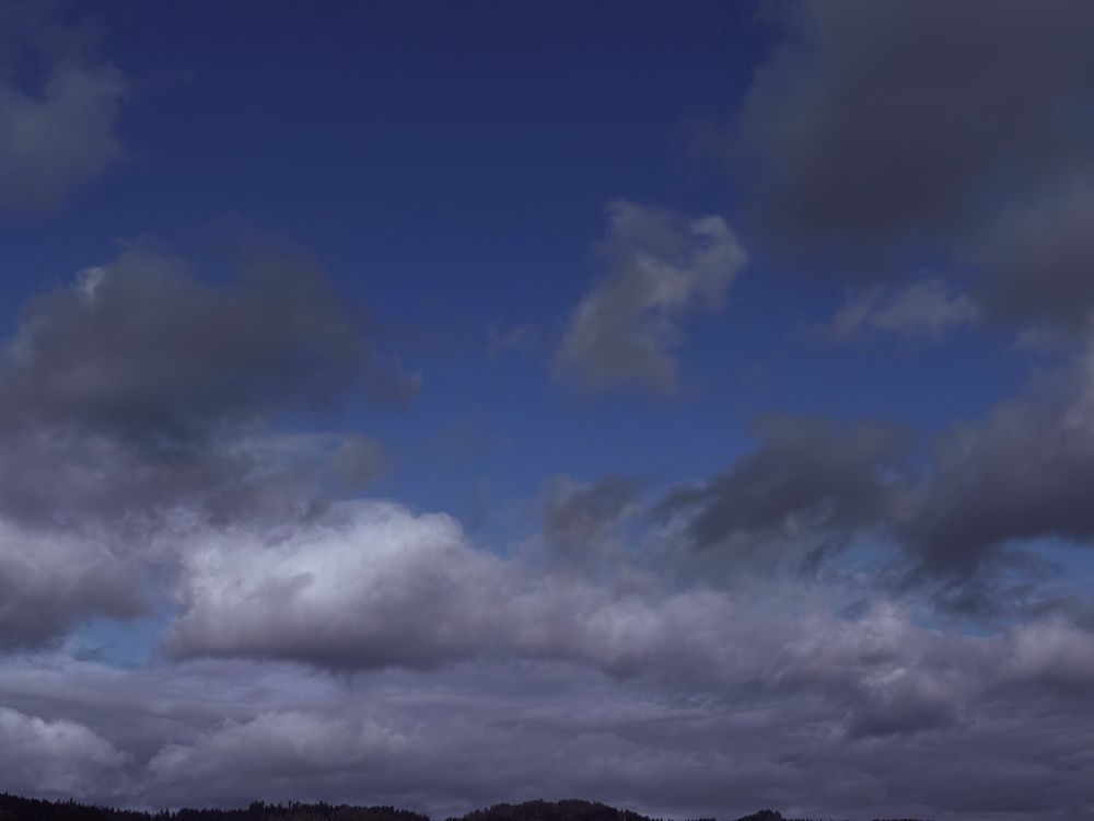 A photo of clouds looking a little menacing on a blue, sunny day 