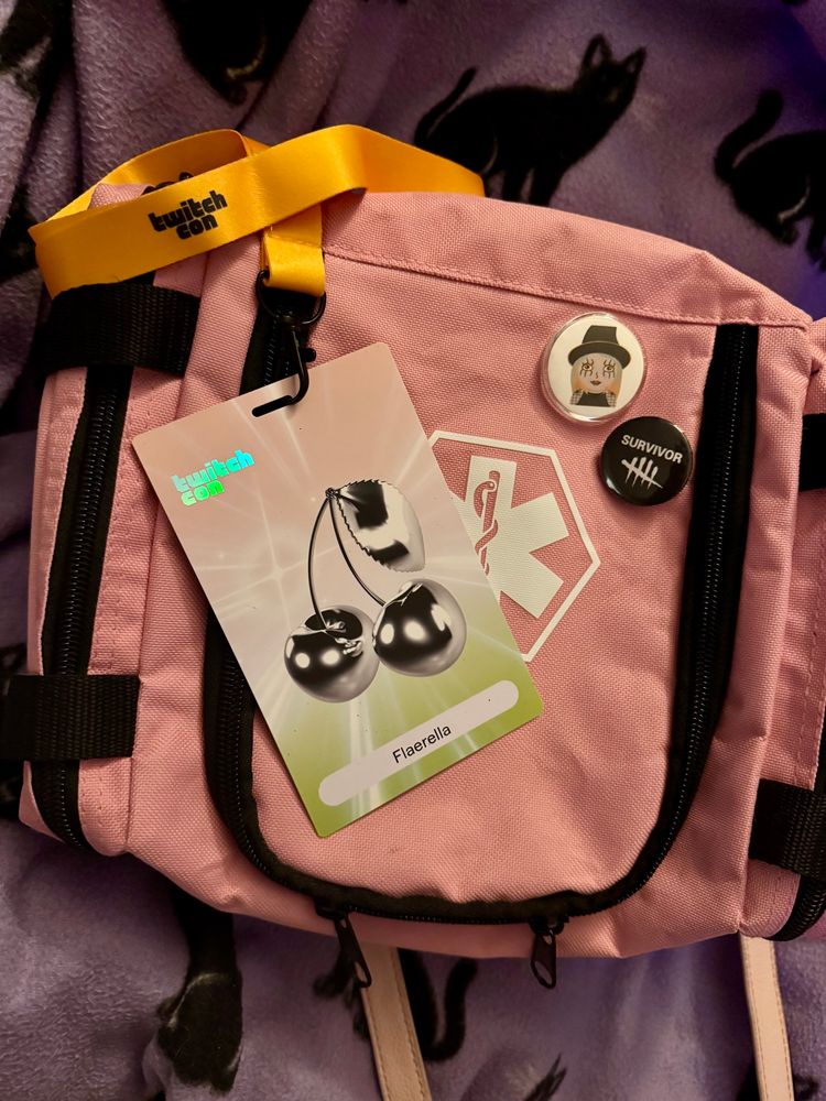 Photo of Flaerella’s medical kit bag with her Twitch Con badge and some Dead by Daylight themed buttons on top