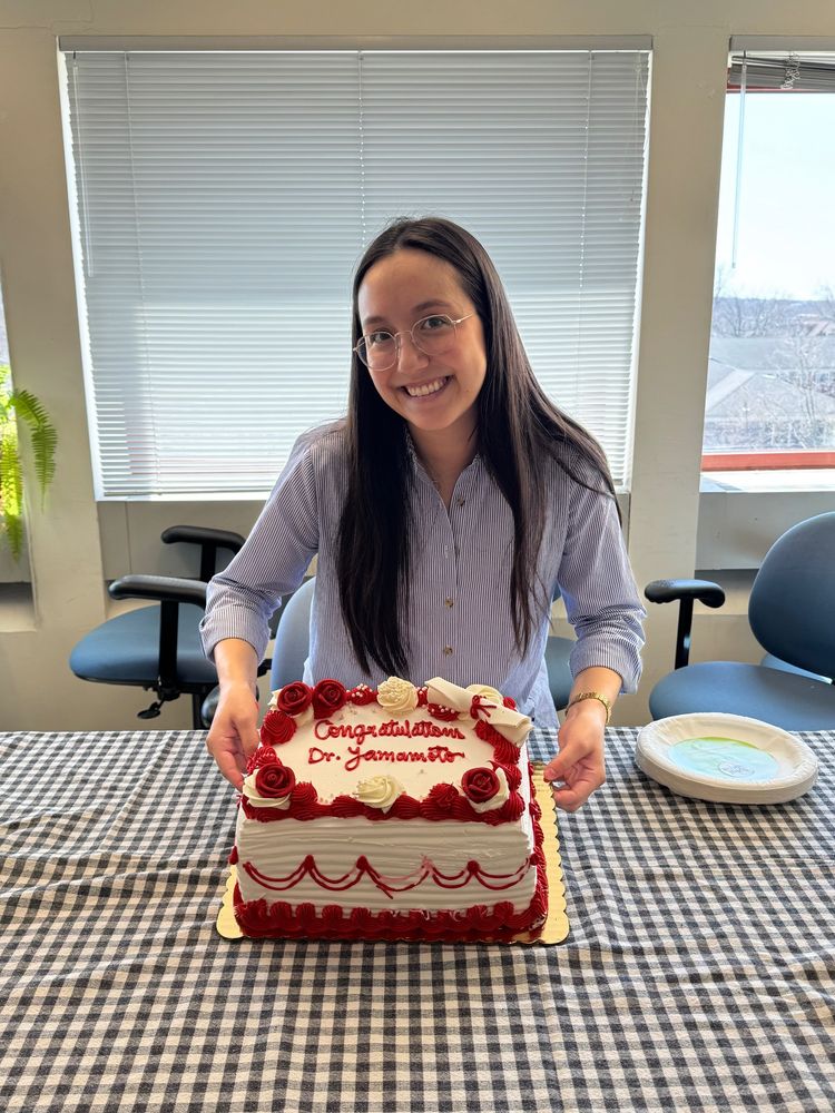 Kat Yamamoto with cake inscribed “Congratulations Dr. Yamamoto”