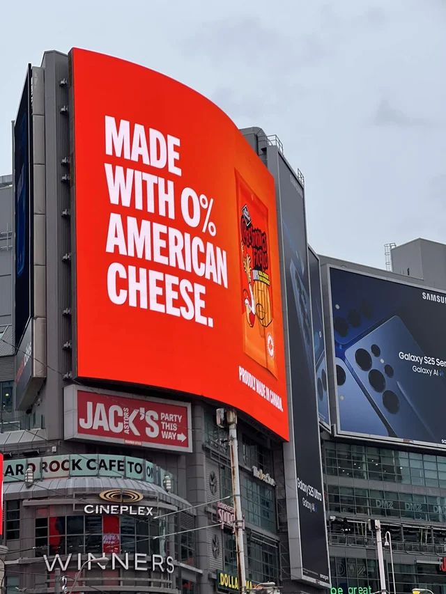 Billboard for cheestrings snacks reading "MADE WITH ZERO PERCENT AMERICAN CHEESE"