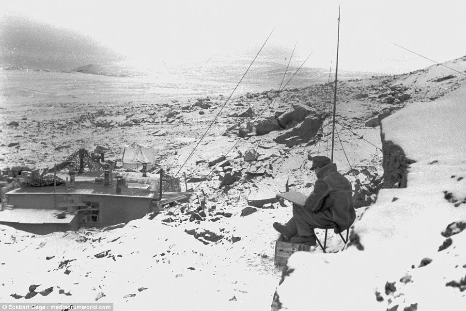 A man wrapped up against the cold, surveys a frozen plain