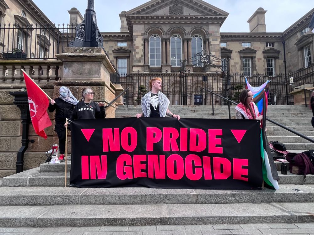No Pride In Genocide banner on the steps of Belfast Custom House.
