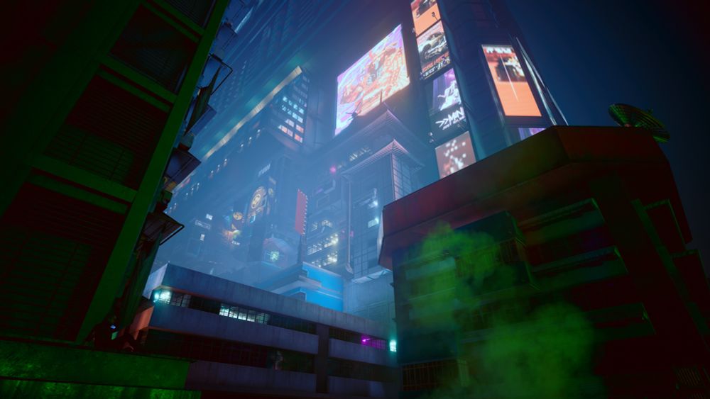 A different angle from slightly below now, V is sitting on the ledge and there is a skyscraper with lots of shiny lights and billboards towering over V. 