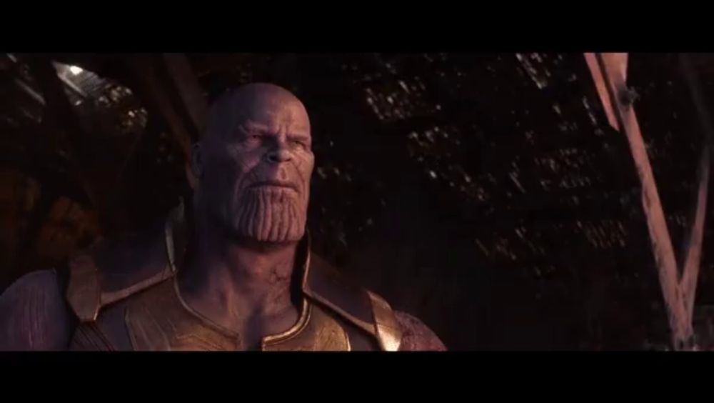 a close up of thanos ' face with a beard in a dark room