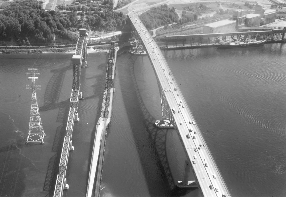 Aerial view of three bridges over Second Narrows: New rail bridge (1969), original Second Narrows Bridge (1925) and new Second Narrows Bridge (1960).   Courtesy of MONOVA/North Vancouver Archives, Inventory No 10006 