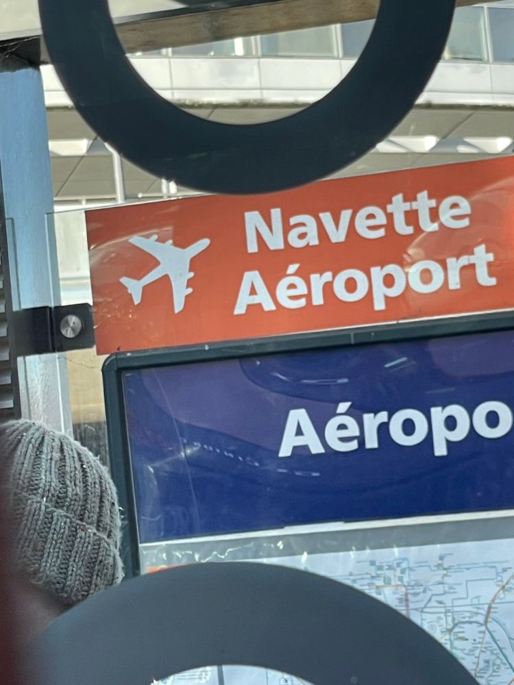An airport shuttle sign