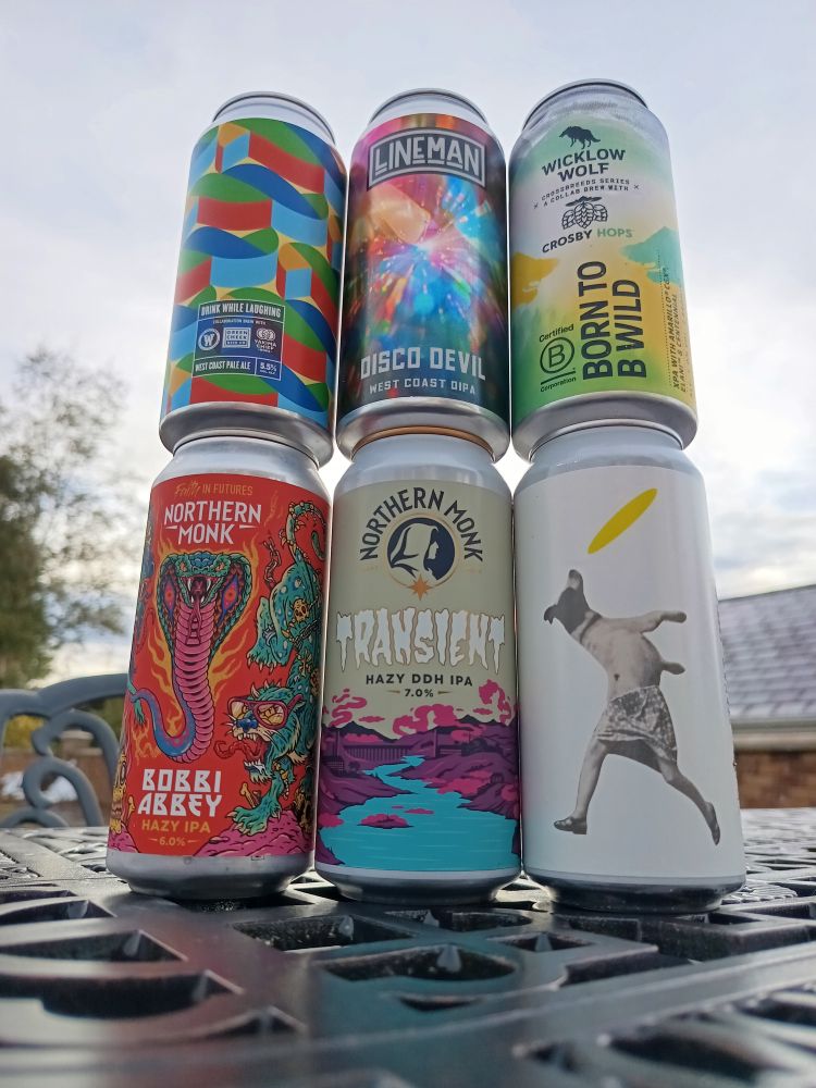 6 cans of IPA on a wet table 