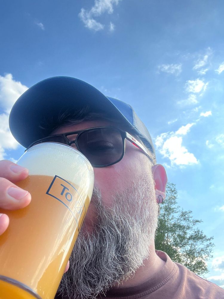 Bearded man with a glass of hazy beer