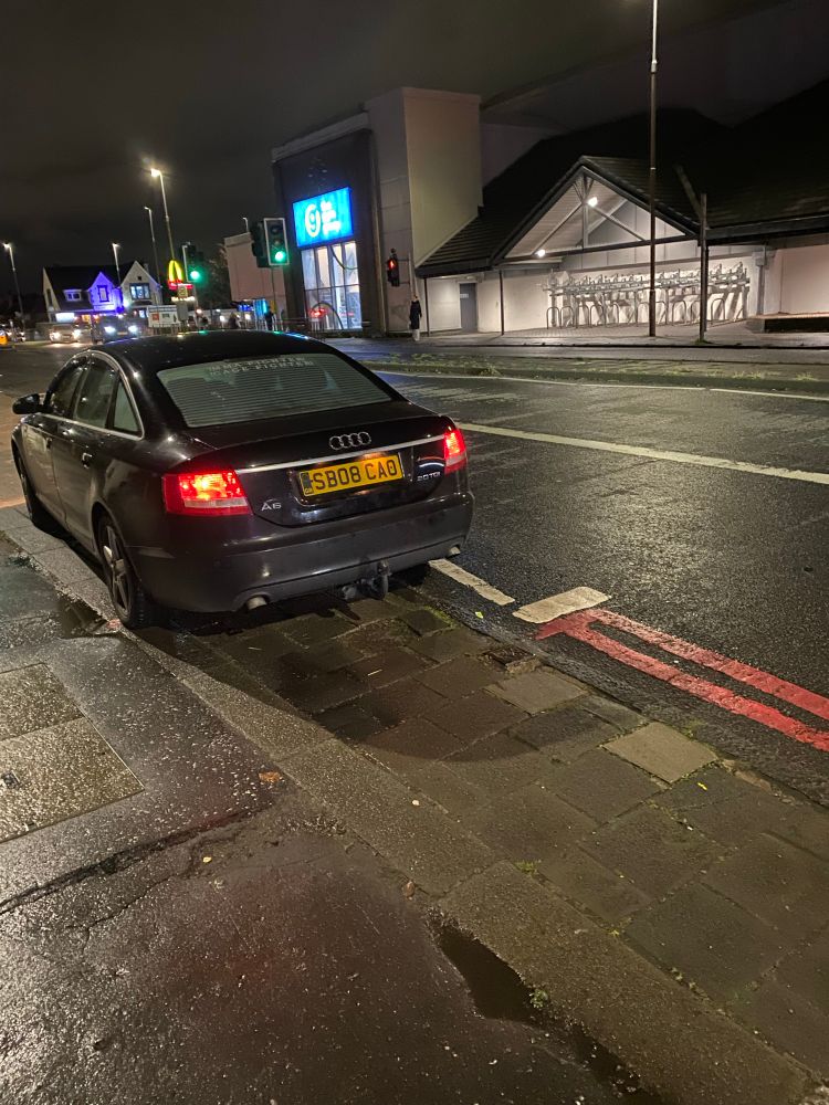 A car parked on the pavement and crossing lines just near Drum Brae roundabout on Corstorphine, Edinburgh.