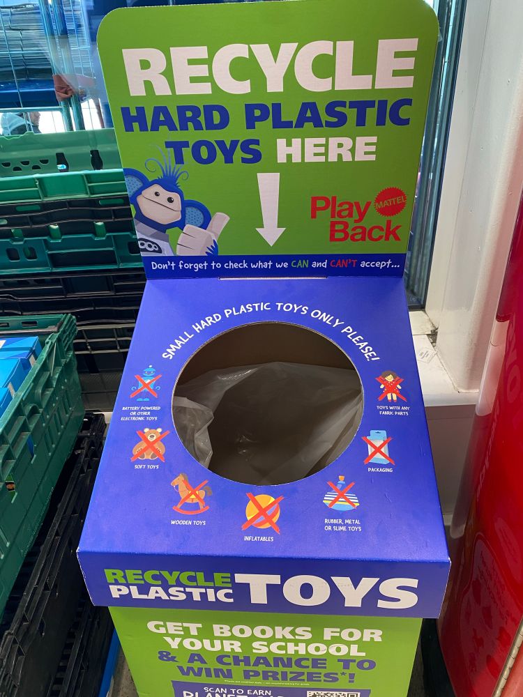A recycling box with “ recycle hard plastic toys here” emblazoned upon it.