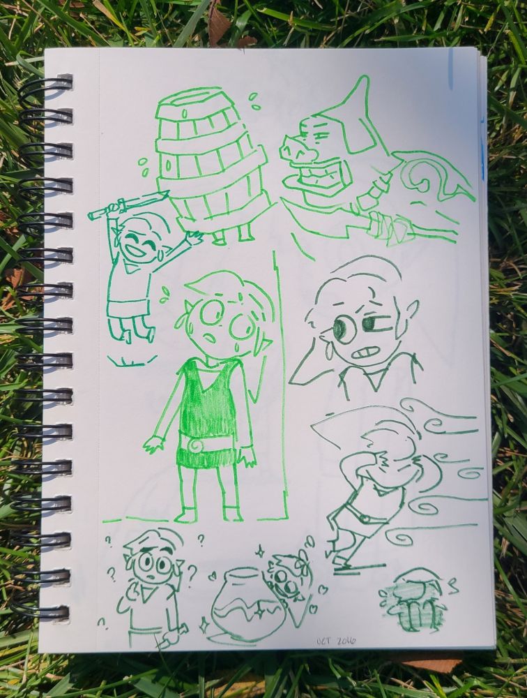 A sketchbook sitting in the grass filled with drawings of toon link from legend of zelda
