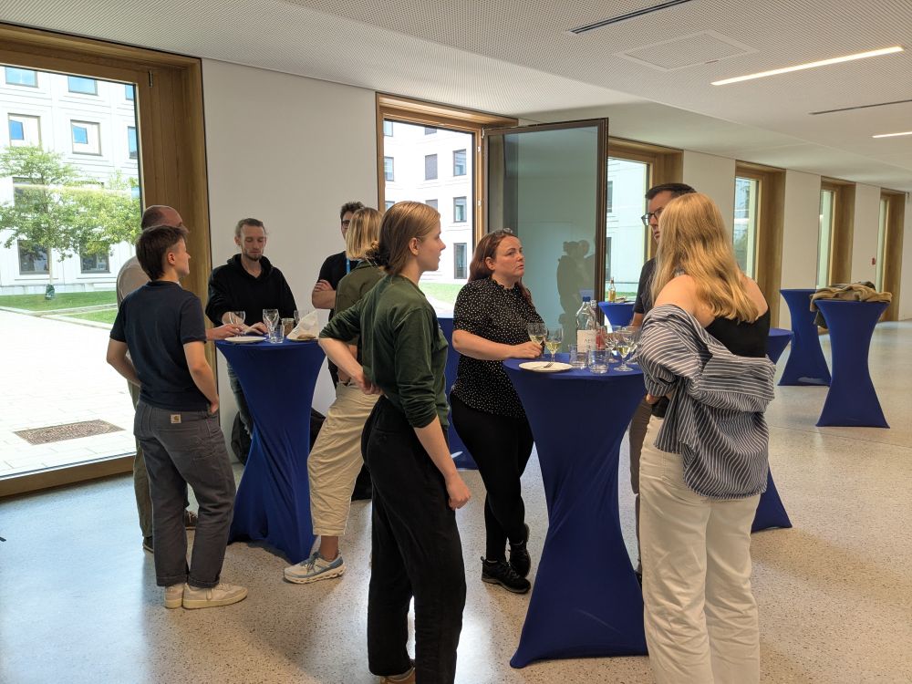 Participants gathering in the foyer for their get together.
