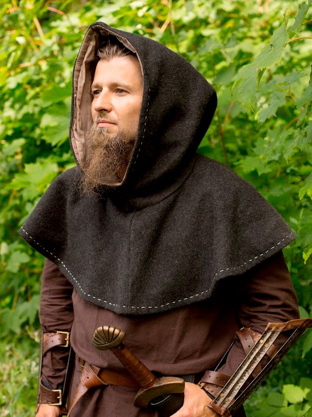 A bearded man in plain medieval European garb, most notably a gugel, which is basically a hood with extra cloth that covers the shoulders, upper chest, and upper back.