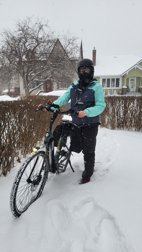 Me standing next to my bike in a spring storm. Lots of light, fluffy snow! 