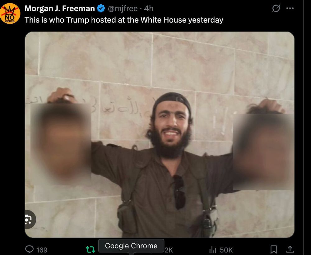 Image of white house guest holding two decapitated heads *blurred out* while he smiles
