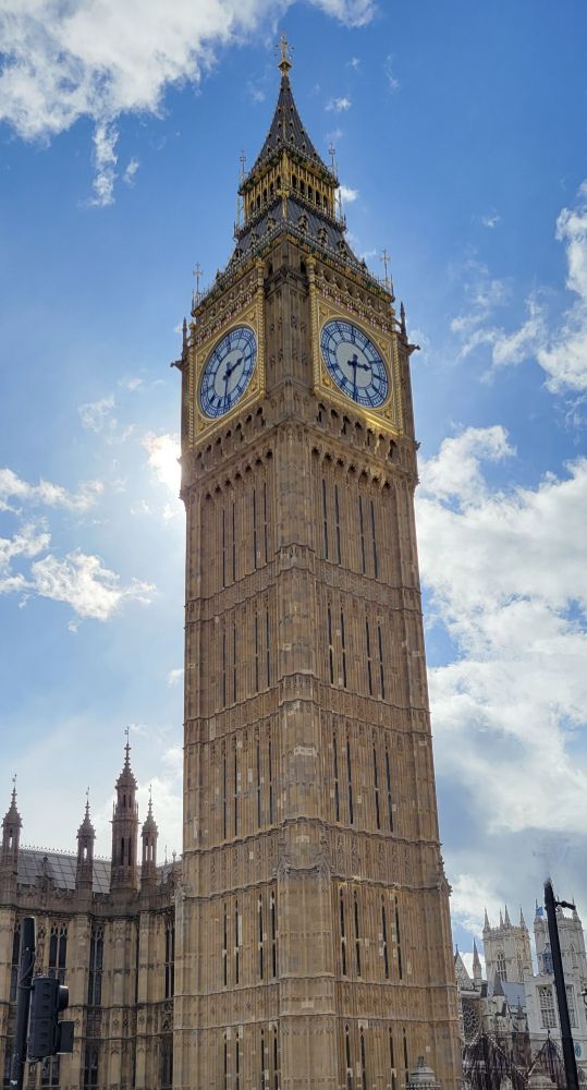 The tower and clock shot from below on a sunny day.