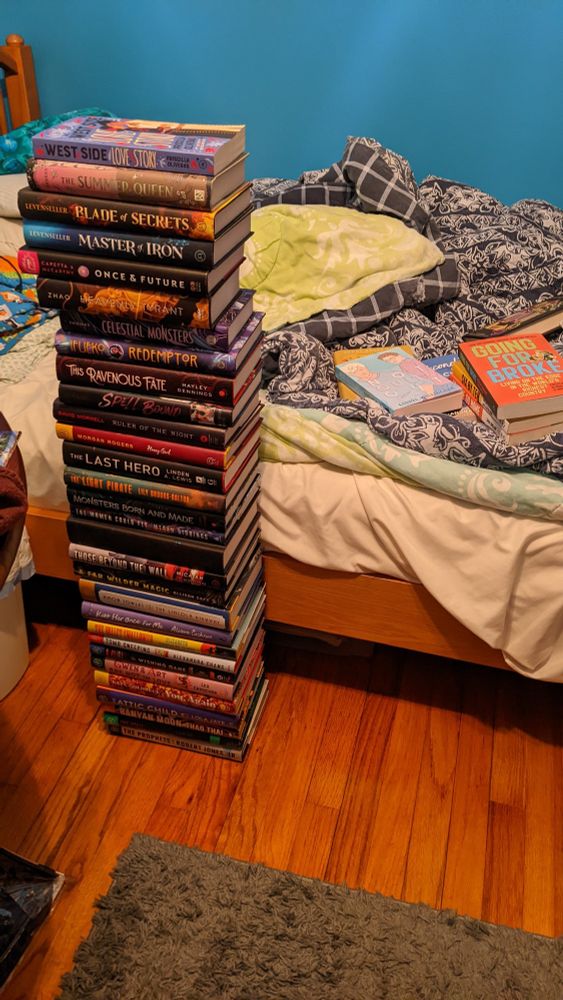 A tower of hardback books stacked very precariously