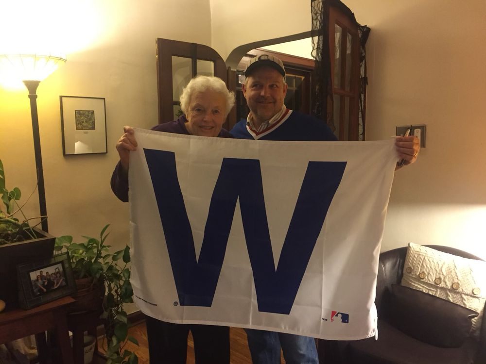 My mom and I with the W Flag the night the Cubs won the pennant. 