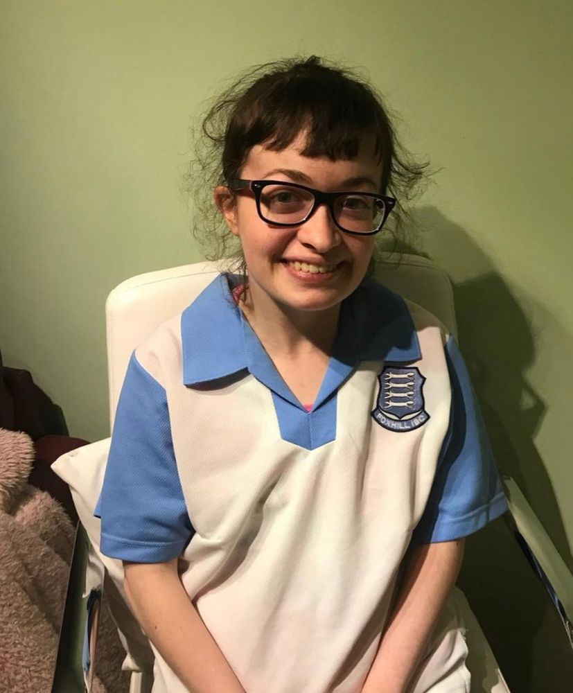 Social media personality Kate King wearing a large Foxhill Indoor Bowls Club t-shirt and smiling.