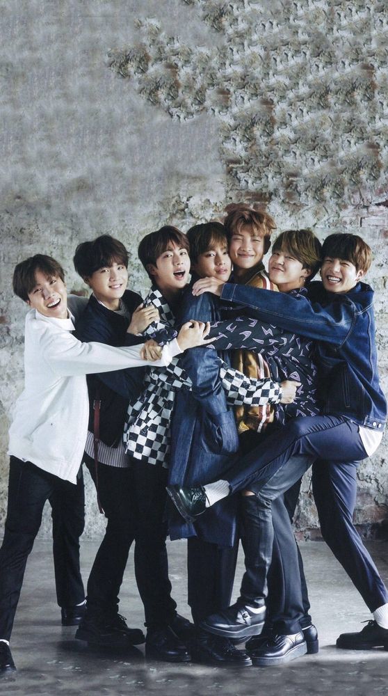 All seven members posing while having a group hug. 