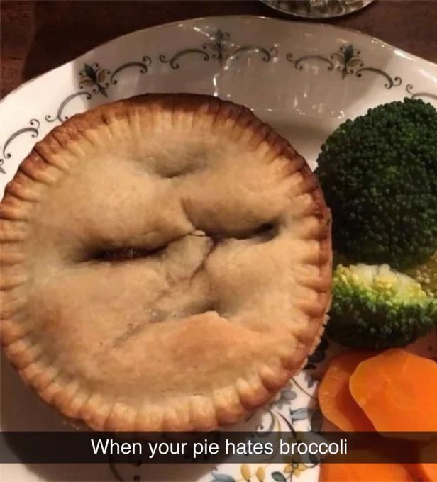 a pie with a carved face in it staring at the broccoli on the right of it, with snapchat text "When your pie hates broccoli"