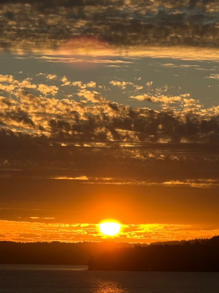 A beautiful sunset between clouds, above the Pugent Sound.