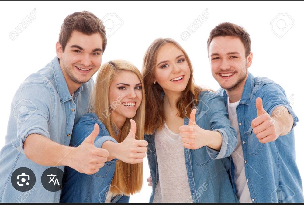 Four people smiling and giving a thumbs up to the camera