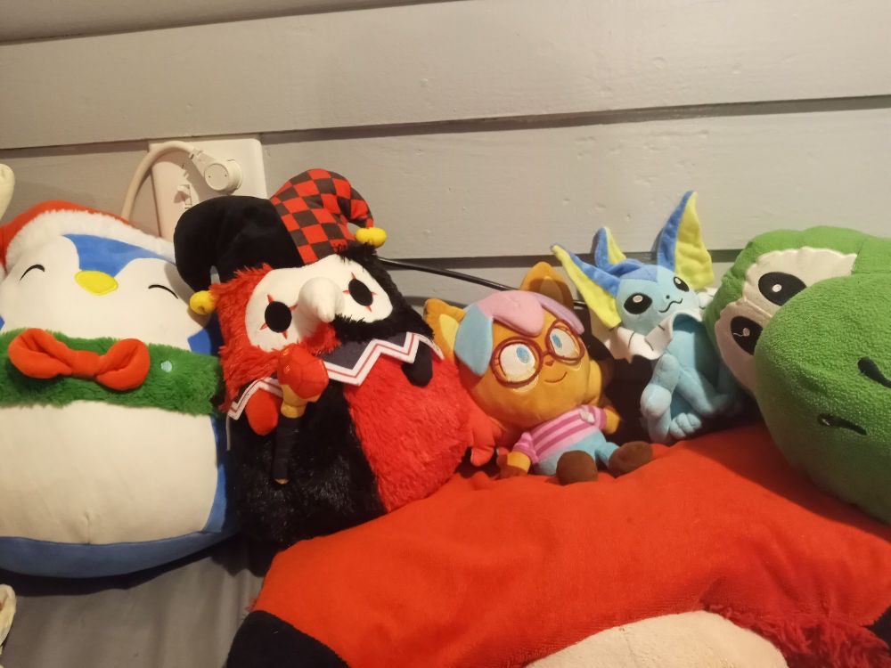 Lil Mel with all the other plushies on my bed. Including Bush the penguin, Jingles/Jimbo the plague joker, Melody, 4chan the Vaporion, and Yasho