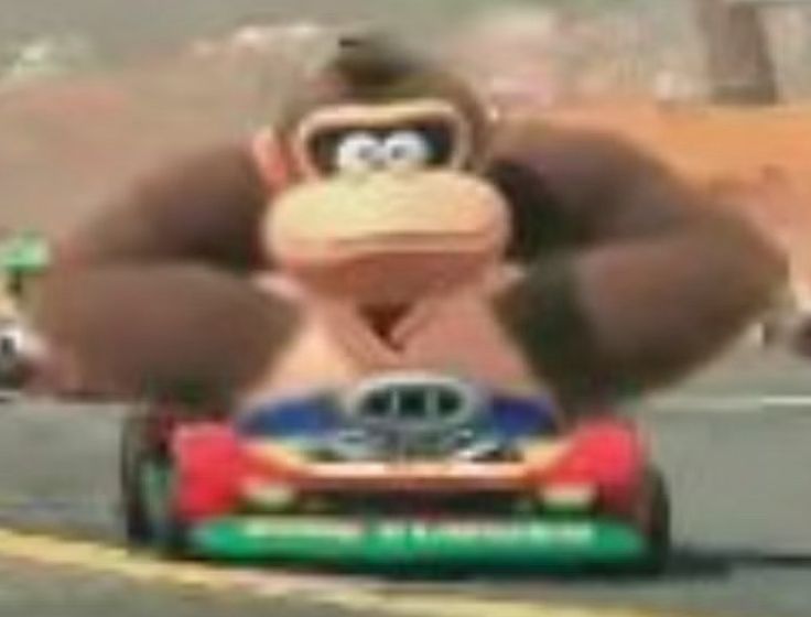 Low-res image of the Donkey Kong redesign for the new Mario Kart. He is crammed into a tiny kart with his elbows spread out.